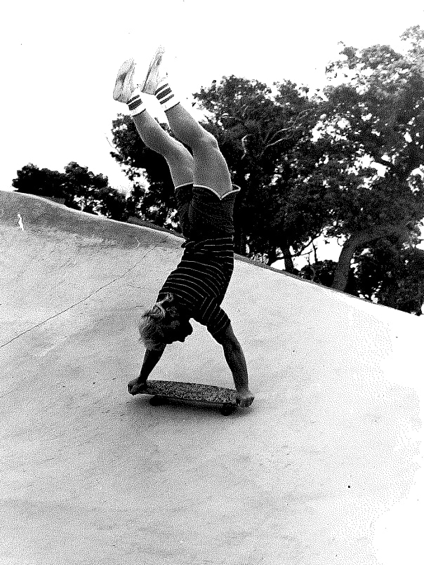 Russ Howell does a handstand on their board. 