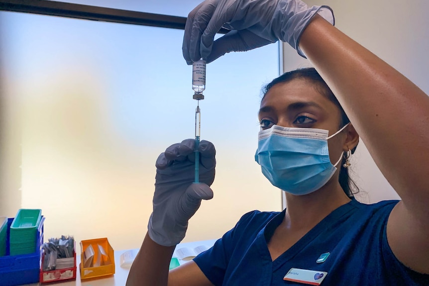 Nurse holding a syringe and vial