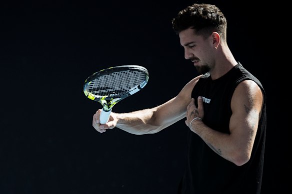 Thanasi Kokkinakis grimaces in pain and feels his injured pec during a practice session at last year’s Australian Open.