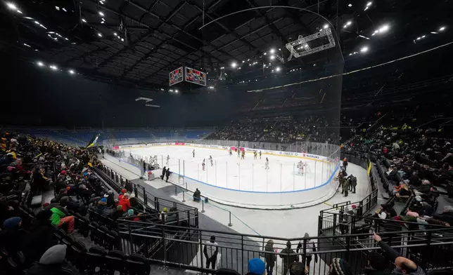 Players battle for the puck during an Hockey Italy's Cup semifinals, SV between Kaltern Caldaro Rothoblaas and HCMV Varese Hockey, at the Olympic test event at the Ice Ockey Arena, in Milan, Italy, Friday, Jan. 9, 2026. (AP Photo/Luca Bruno)