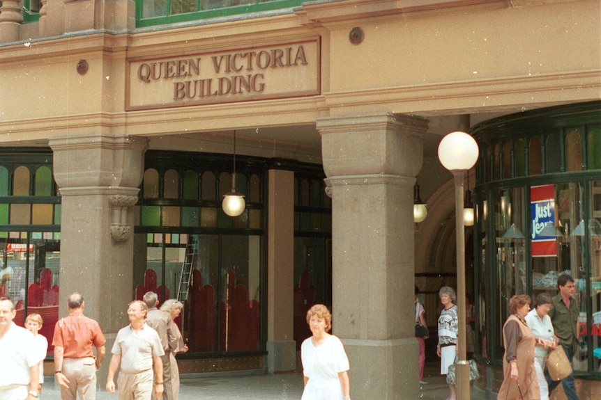 People walk outside QVB