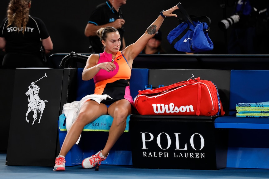 Aryna Sabalenka throws her bag while sitting in her seat after the Australian Open final.