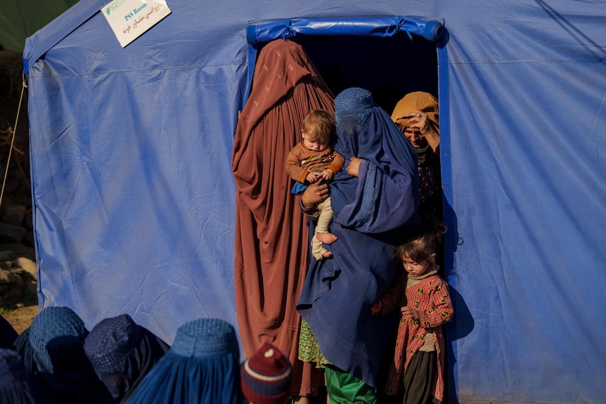 Two women get medical support in a temporary medical clinic in Afghanistan.