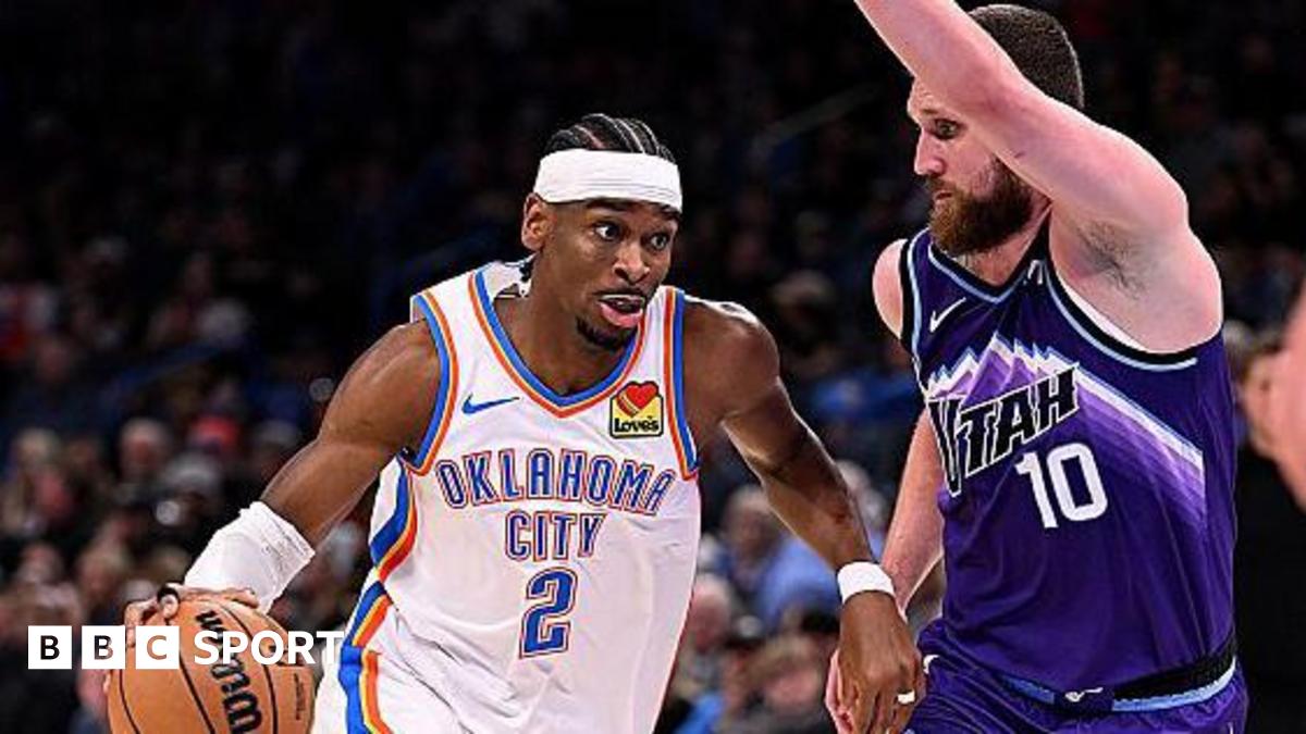 Shai Gilgeous-Alexander of the Oklahoma City Thunder attempts to drive past Svi Mykhailiuk of the Utah Jazz