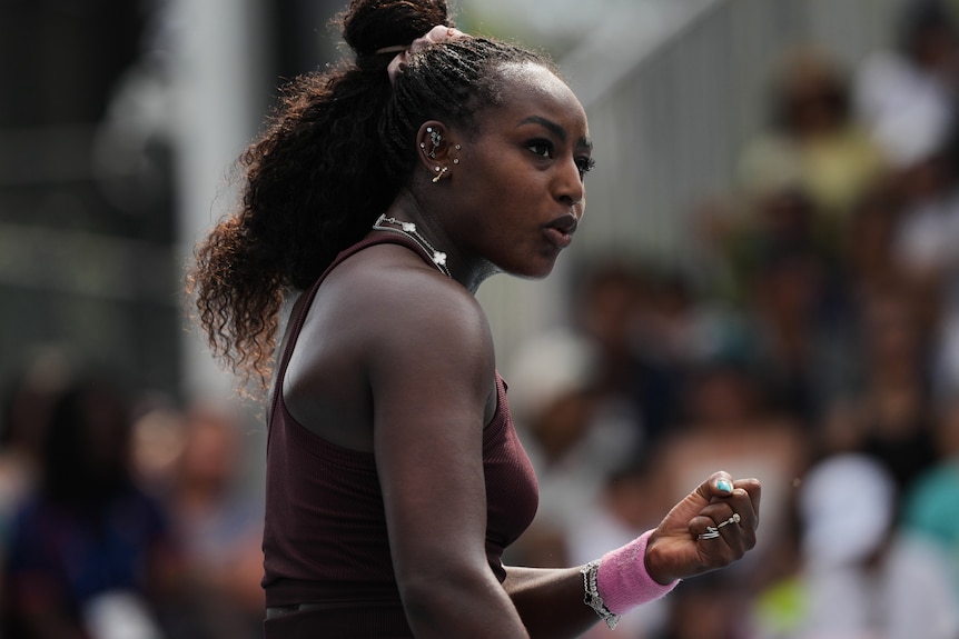 ALycia Parks clenches her fist during a tennis match at the Australian Open.