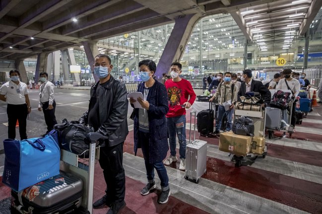 Tourists being screened at a Bangkok airport during the COVID-19 pandemic.