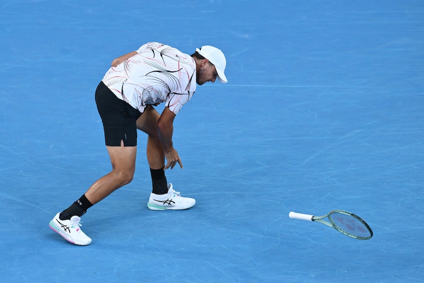 Luciano Darderi throwing his racquet onto the floor
