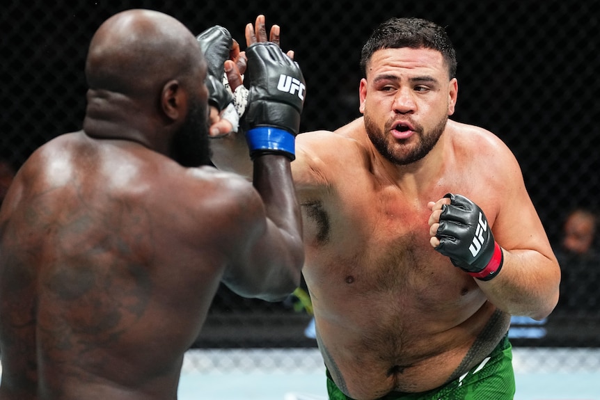 Tai Tuivasa throws a punch at Derrick Lewis in their UFC fight.