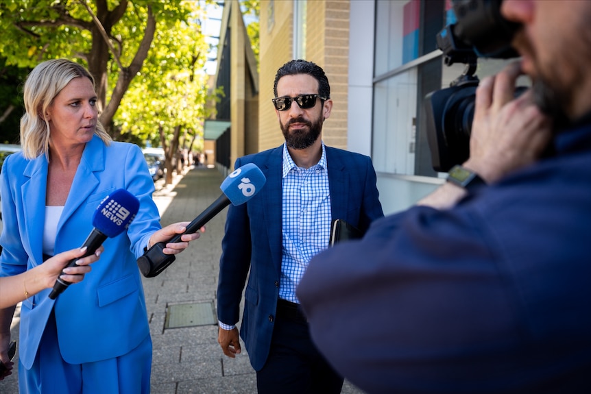 A man is talking to media