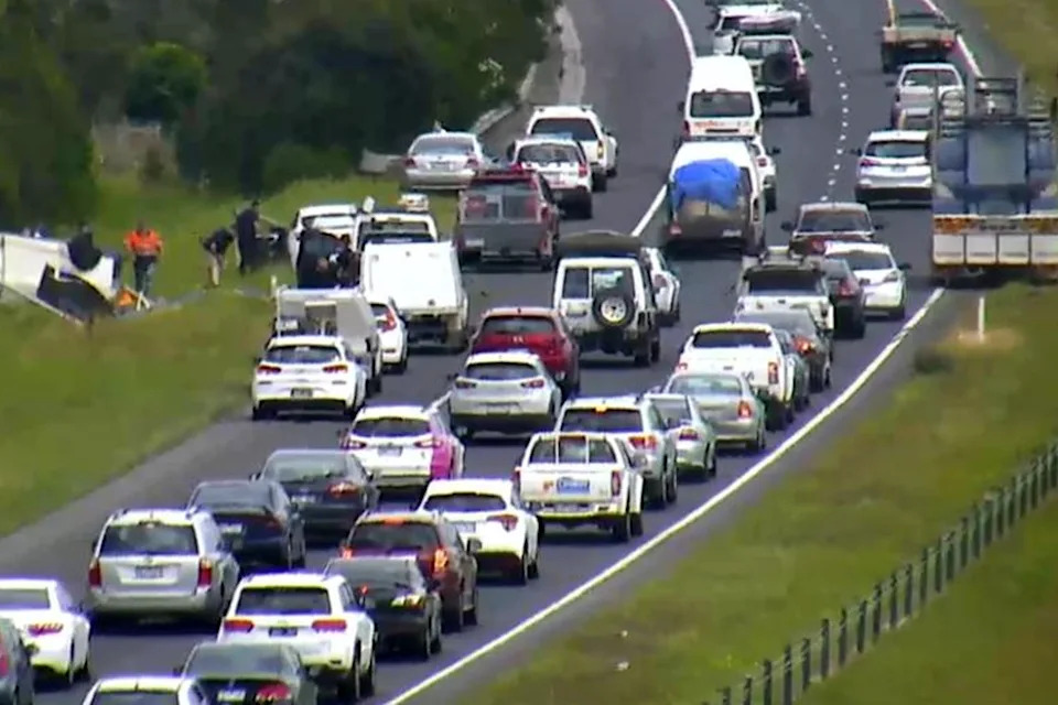 A busy highway in Victoria with a crash seen on the left. 