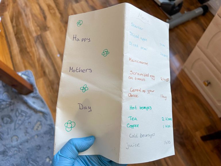 While cleaning through a hoarder's bedroom, Jo Powell finds a menu written by the client's daughter for Mothers' Day, a sweet reminder of her childhood. [Amandas Ong/Al Jazeera]