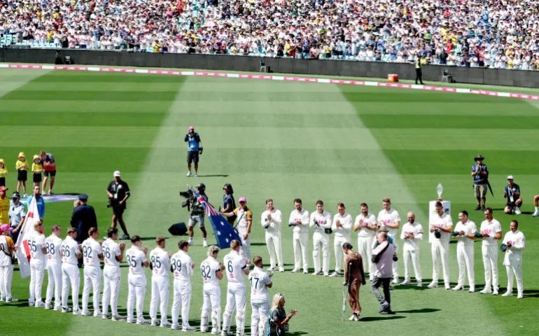 Emergency service personnel and members of the public who responded during a mass shooting at Bondi Beach including Ahmed al Ahmed (R), the man who tackled and disarmed one of the attackers, receive a guard of honour on day one of the fifth Ashes cricket Test match between Australia and England at the Sydney Cricket Ground (SCG) in Sydney on January 4, 2026. England and Australia's cricket teams honoured at the fifth Ashes Test in Sydney on January 4 emergency service personnel and members of the public who responded during a mass shooting at Bondi Beach. (Photo by Glenn NICHOLLS / AFP) / --IMAGE RESTRICTED TO EDITORIAL USE - STRICTLY NO COMMERCIAL USE--