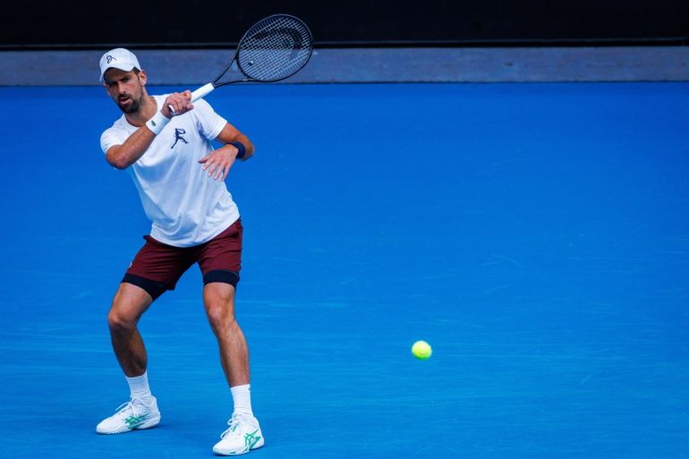 Serbias Novak Djokovic hits a forehand during a training session against Czech Republic Jiri Lehecka in preparation for the Australian Open in Melbourne on January 13, 2026. (Photo by Patrick HAMILTON / AFP) / - IMAGE RESTRICTED TO EDITORIAL USE - STRICTLY NO COMMERCIAL USE -