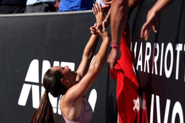 Turkeys Zeynep Sönmez celebrates with teammates after defeating Russias Ekaterina Alexandrova in their womens singles match on day one of the Australian Open in Melbourne on January 18, 2026. (Photo by DAVID GRAY / AFP) / -- IMAGE RESTRICTED TO EDITORIAL USE - STRICTLY NO COMMERCIAL USE --