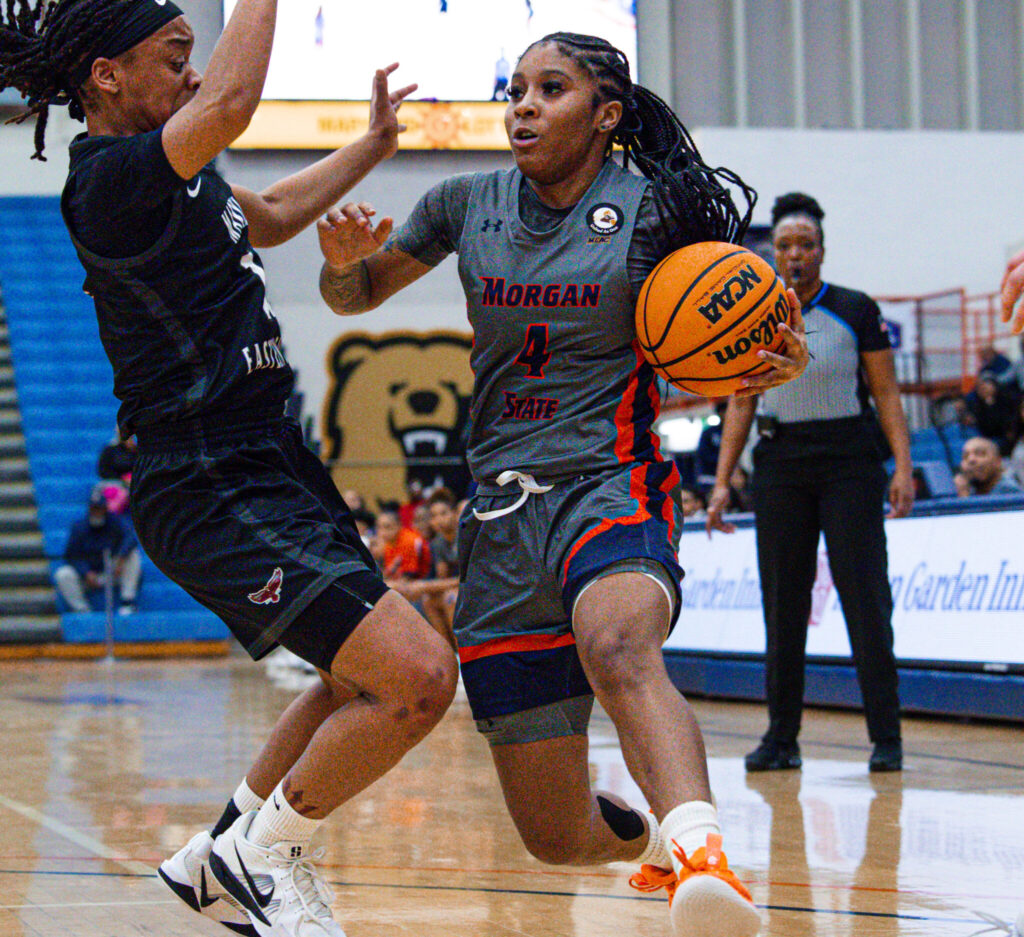 Ja'la Bannerman has the ball is being guarded closely by a defender.