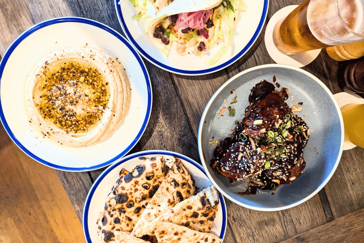 A table of sharing plates of food.