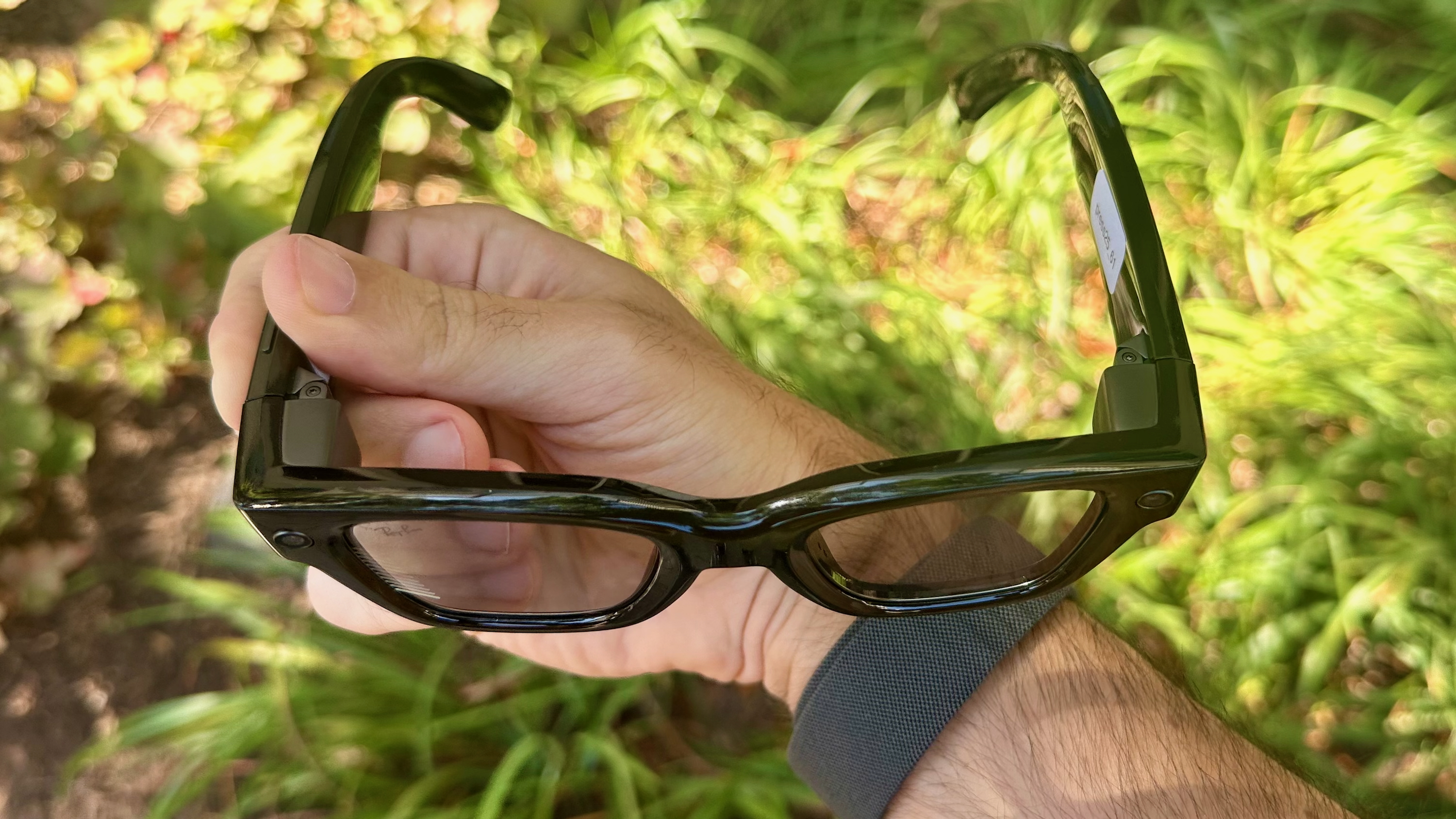 A photo of the Meta Ray-Ban Display glasses held from the top-down.