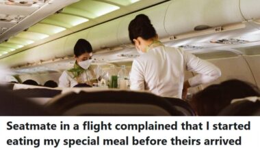 Flight attendants working their way through the plane, serving food and drinks