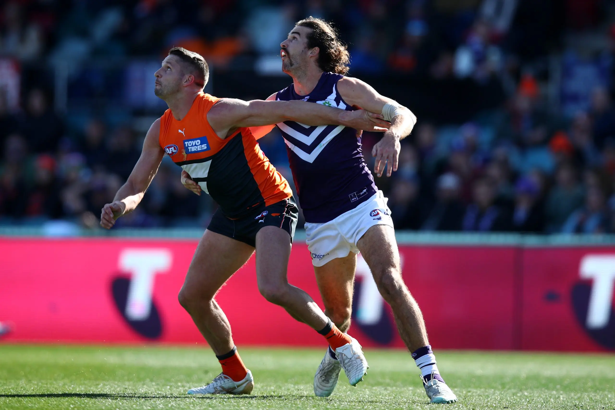 CANBERRA, AUSTRALIA - AUGUST 20: Alex Pearce of the Dockers and Jesse Hogan of the Giants compete for the ball during the round 23 AFL match between the Greater Western Sydney Giants and the Fremantle Dockers at Manuka Oval on August 20, 2022 in Canberra, Australia. (Photo by Jason McCawley/AFL Photos/via Getty Images)