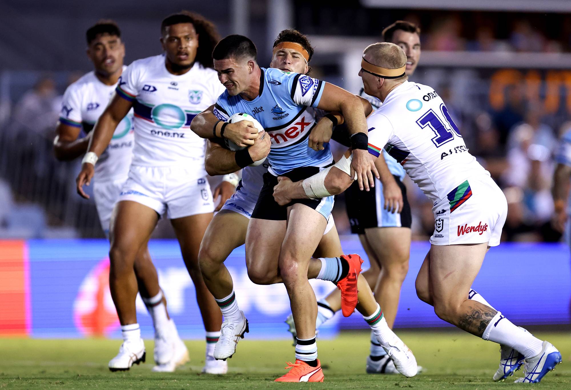 SYDNEY, AUSTRALIA - FEBRUARY 07: Daniel Atkinson of the Sharks is tackled by the Warriors defence during the NRL pre-season match between Cronulla Sharks and New Zealand Warriors at Sharks Stadium on February 07, 2025 in Sydney, Australia. (Photo by Brendon Thorne/Getty Images)