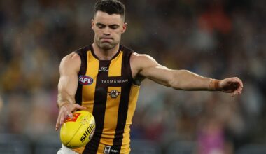 MELBOURNE, AUSTRALIA - MARCH 20: Conor Nash of the Hawks kicks ahead during the round two AFL match between Carlton Blues and Hawthorn Hawks at Melbourne Cricket Ground on March 20, 2025, in Melbourne, Australia. (Photo by Robert Cianflone/Getty Images)