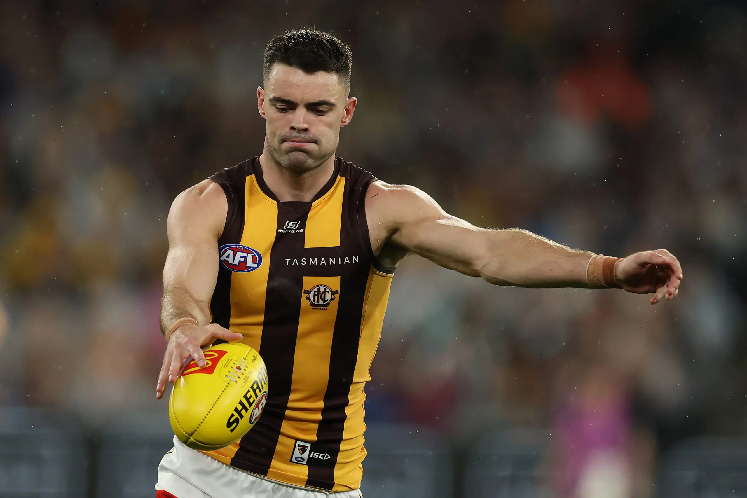 MELBOURNE, AUSTRALIA - MARCH 20: Conor Nash of the Hawks kicks ahead during the round two AFL match between Carlton Blues and Hawthorn Hawks at Melbourne Cricket Ground on March 20, 2025, in Melbourne, Australia. (Photo by Robert Cianflone/Getty Images)