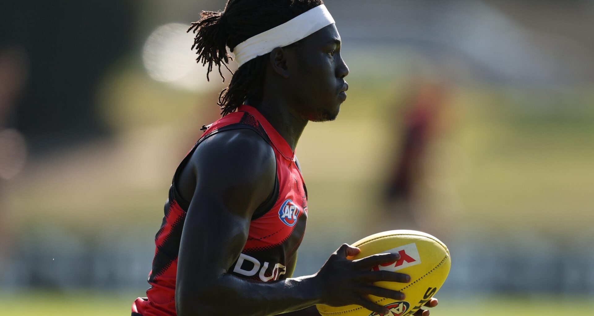 MELBOURNE, AUSTRALIA - APRIL 09: Luamon Lual of the Bombers runs with the ball during an Essendon Bombers AFL training session at The Hangar on April 09, 2025 in Melbourne, Australia. (Photo by Robert Cianflone/Getty Images)