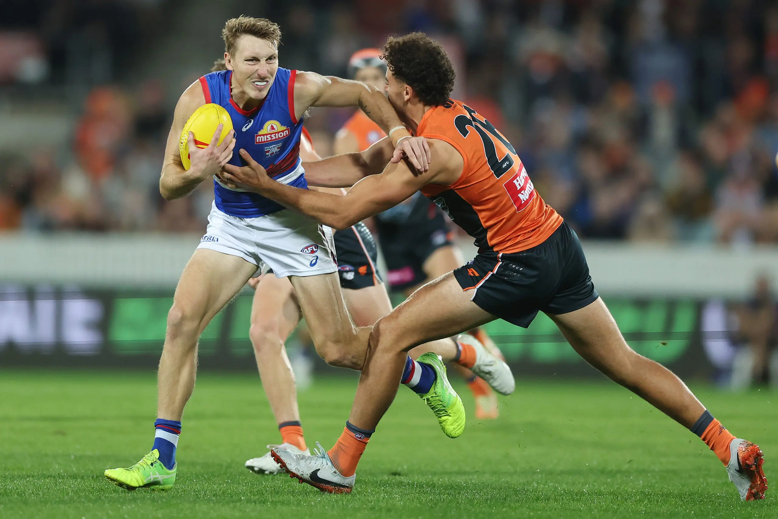 CANBERRA, AUSTRALIA - APRIL 26: Bailey Dale of the Bulldogs breaks the tackle of Jake Riccardi of the Giants during the round seven AFL match between GWS Giants and Western Bulldogs at Manuka Oval, on April 26, 2025, in Canberra, Australia. (Photo by Mark Metcalfe/AFL Photos/via Getty Images)