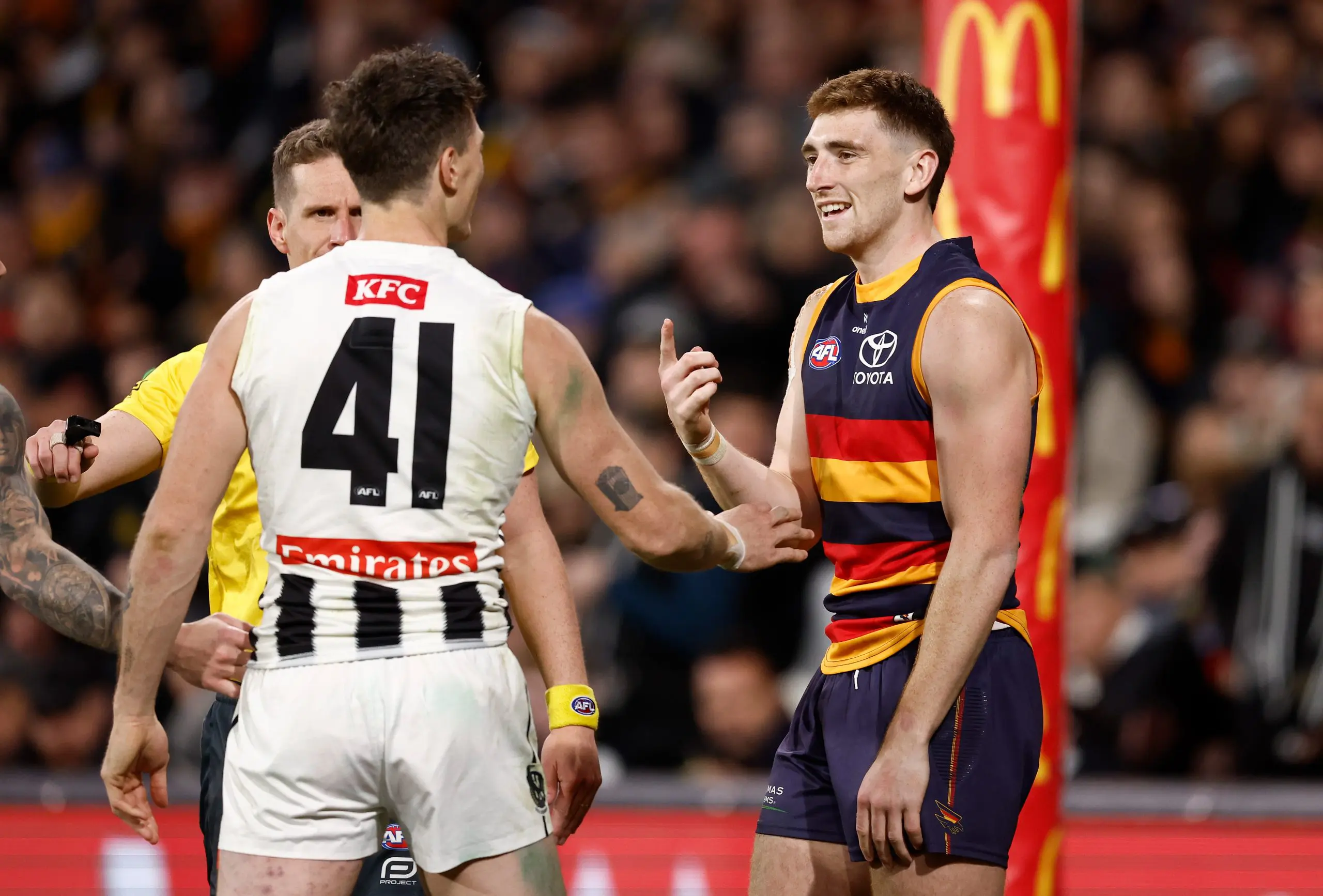 ADELAIDE, AUSTRALIA - SEPTEMBER 04: Brody Mihocek of the Magpies and Mark Keane of the Crows exchange words during the AFL First Qualifying Final match between the Adelaide Crows and the Collingwood Magpies at Adelaide Oval on September 04, 2025 in Adelaide, Australia. (Photo by Michael Willson/AFL Photos via Getty Images)
