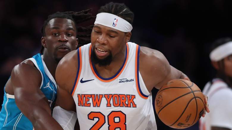 Guerschon Yabusele #28 of the New York Knicks dribbles against Sion James #4 of the Charlotte Hornets during the first half at Madison Square Garden.