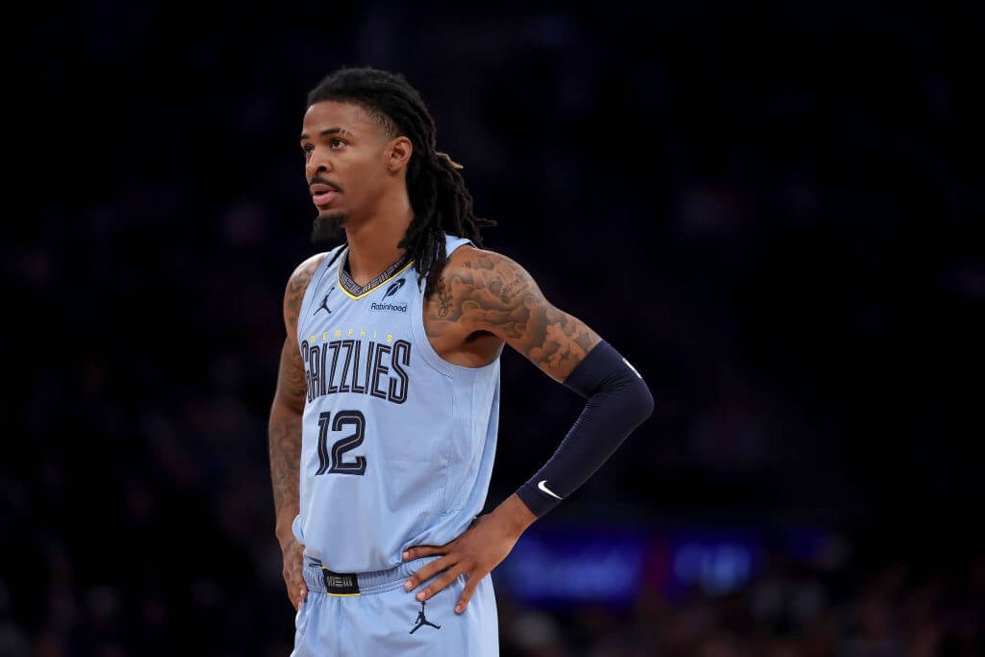 Ja Morant of the Memphis Grizzlies stands on the court with his hands on his hips during a game against the New York Knicks.