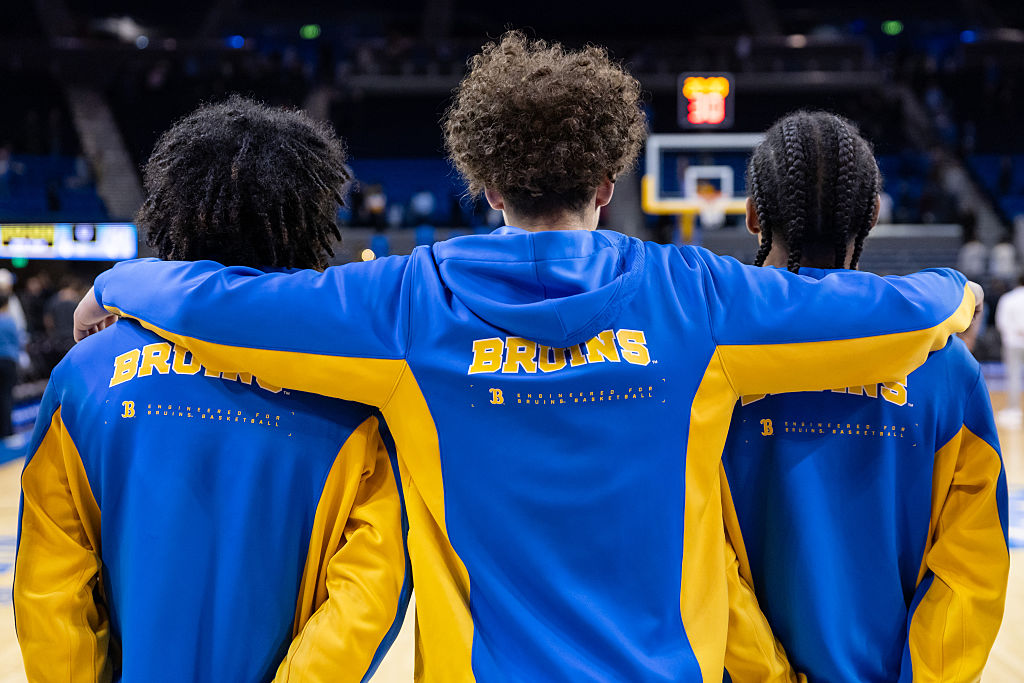 UCLA Bruins players line up for the nation anthem before a game against the Cal Poly Mustangs at Pauley Pavilion on December 19, 2025 in Los Angeles, California.