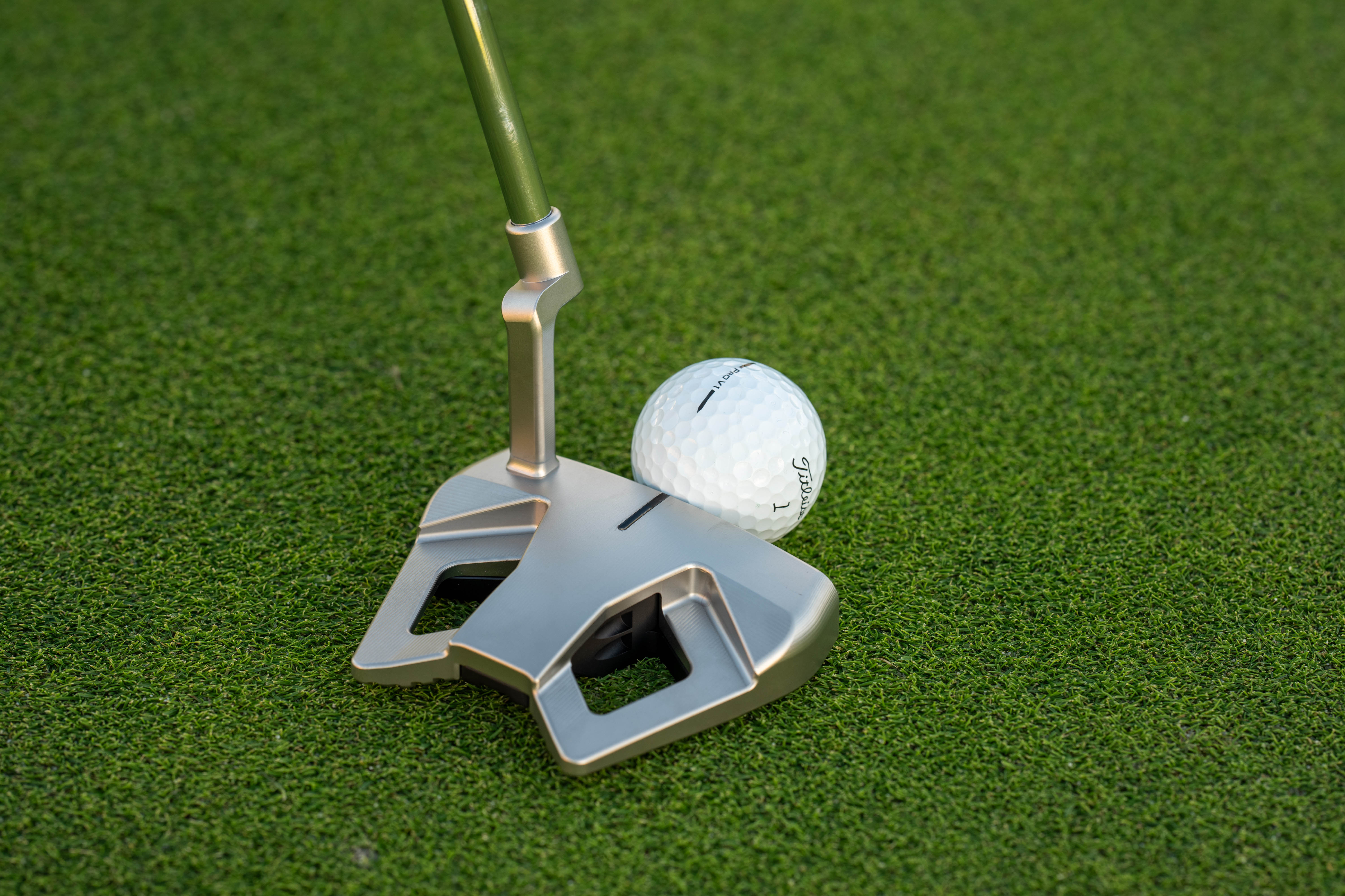A Scotty Cameron putter behind the golf ball