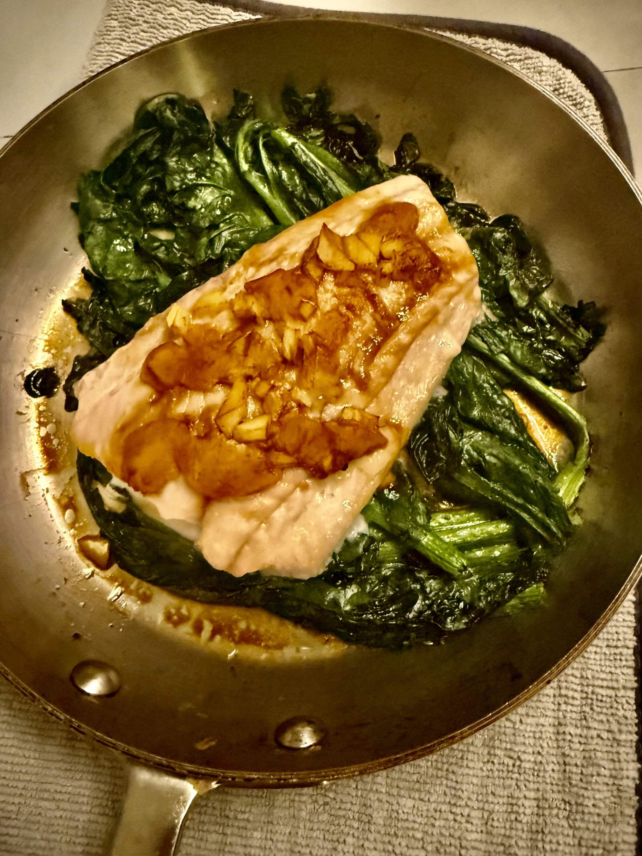 Miso cod on sauteed spinach. (Kathy Gunst/Here & Now)