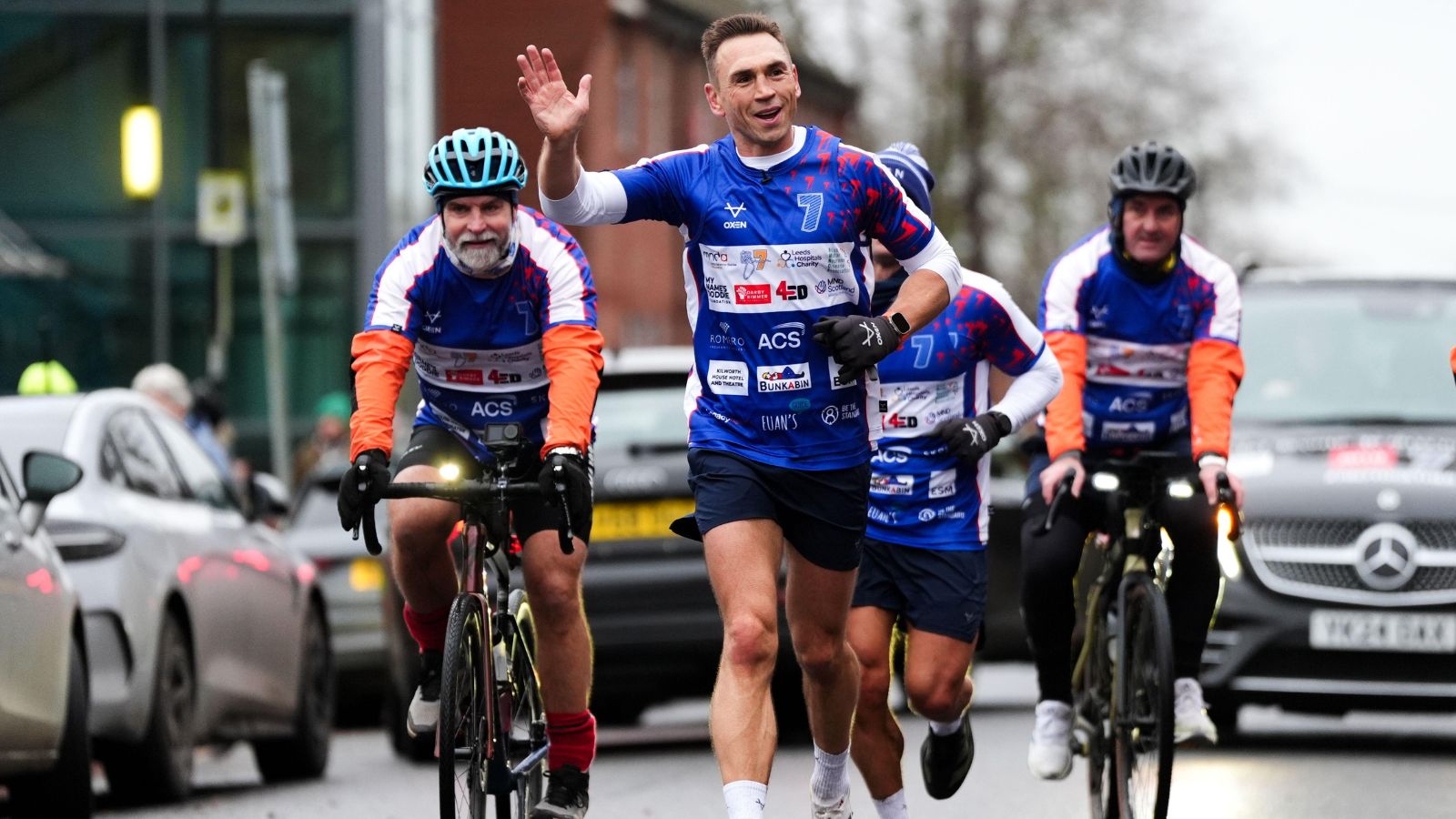 Kevin Sinfield waves to the crowds as he runs from Bury St Edmunds to Ipswich during day one of his '7 in 7: Together' challenge in 2025