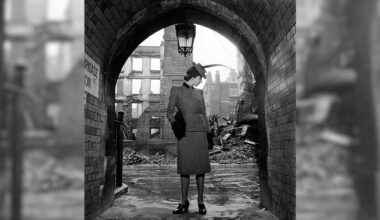 A woman standing in a tunnel.