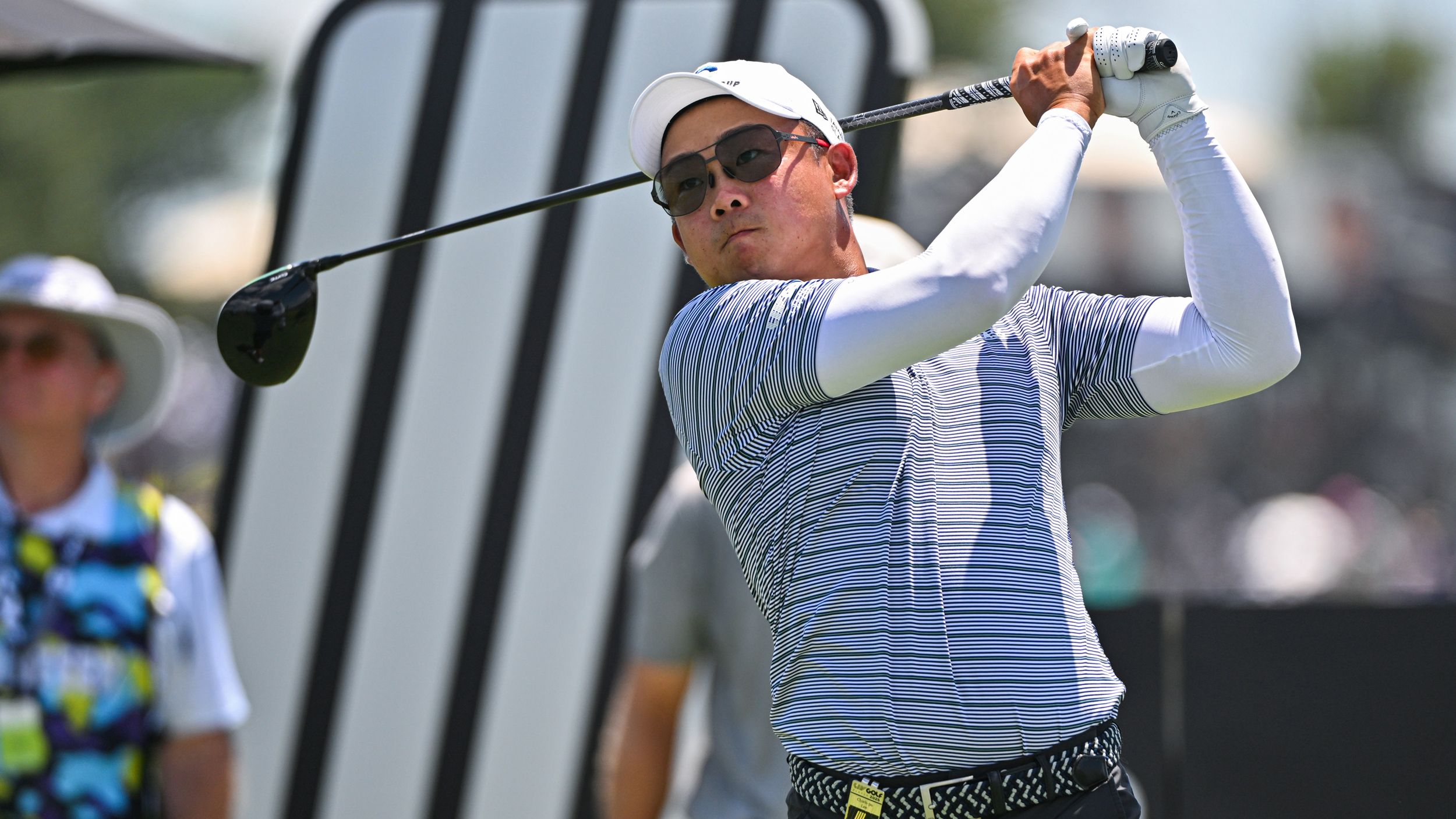 Chieh-po Lee holds his finish on a drive during a LIV Golf event