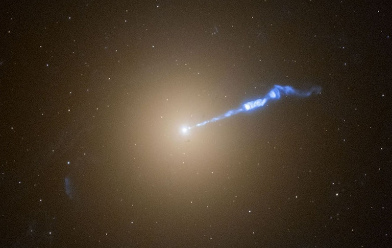 Event Horizon Telescope: Glowing spherical light in the center with a blue streaming jet of gas coming off it in a starry sky.