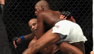 Jon Jones grapples with Daniel Cormier during their fight at UFC 214