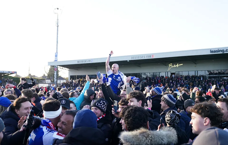 Macclesfield players celebrate with supporters after the victory. (Martin Rickett/PA Images via Getty Images)