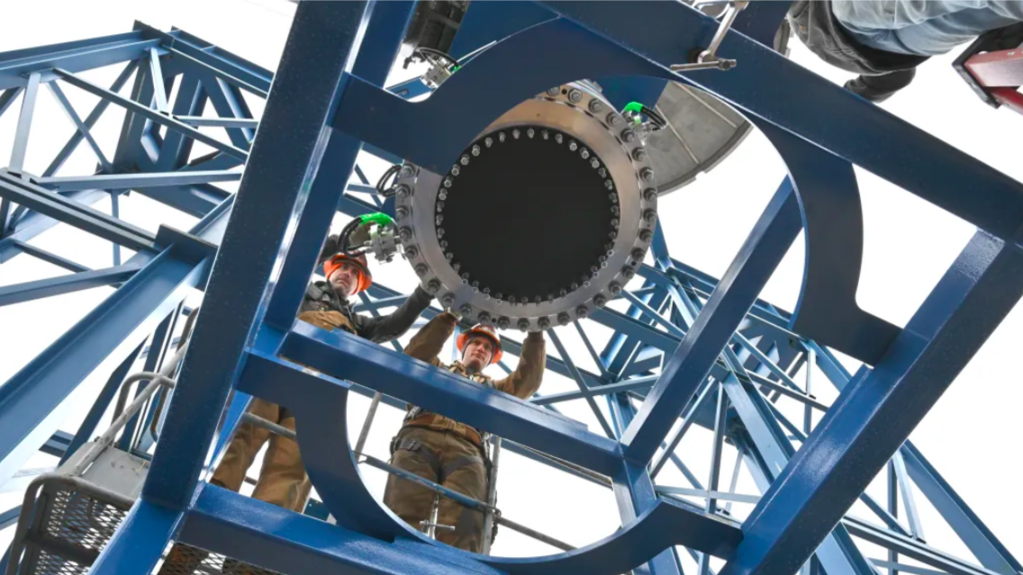 Engineers install a flight reactor engineering development unit into Test Stand 400 in preparation for cold flow testing (Credit : NASA/Adam Butt)