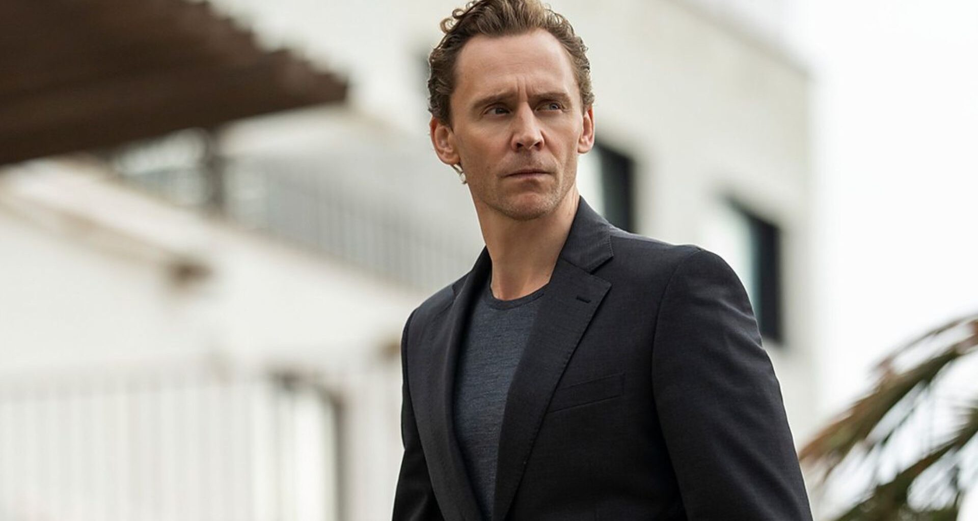 Tom Hiddleston looks at something off camera