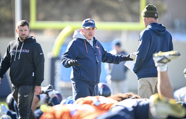 Head coach Sean Payton of the Denver Broncos speaks to offensive coordinator Joe Lombardi during practice at the Broncos Park in Centennial on Thursday. (Photo by AAron Ontiveroz/The Denver Post)