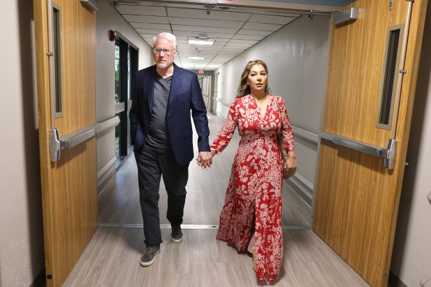 Tim Williams and his wife, Sara Williams, visit Delray Medical Center in Delray Beach, Friday, Jan. 2, 2026. Williams, the director of the hospital's proton therapy center, became a patient there after collapsing at home. He survived a stroke, nine days in a coma, an in-bed surgery and a long recovery. (Carline Jean/South Florida Sun Sentinel)