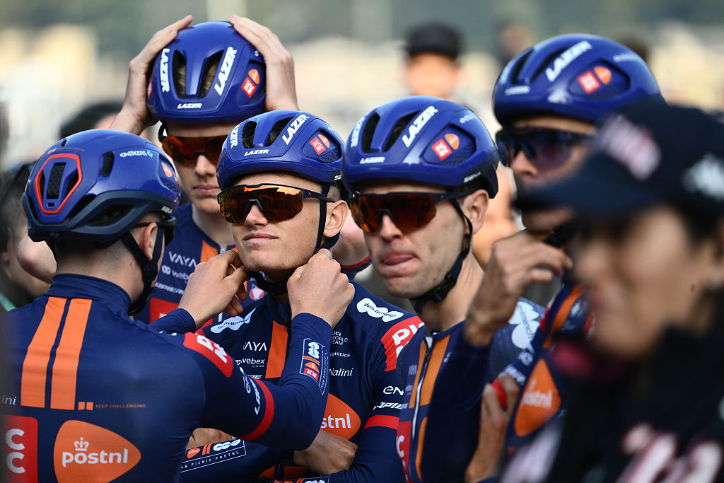 Team Picnic PostNL&rsquo;s British rider Oscar Onley has his helmet adjusted by a teammate ahead of the 119th edition of the Giro di Lombardia (Tour of Lombardy), a 238km cycling race from Como to Bergamo on October 11, 2025. (Photo by Marco BERTORELLO / AFP)