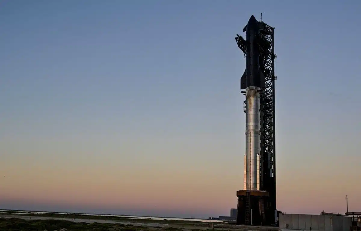 The Spacex Starship Spacecraft Sits Atop The Super Heavy Booster Before Sunrise