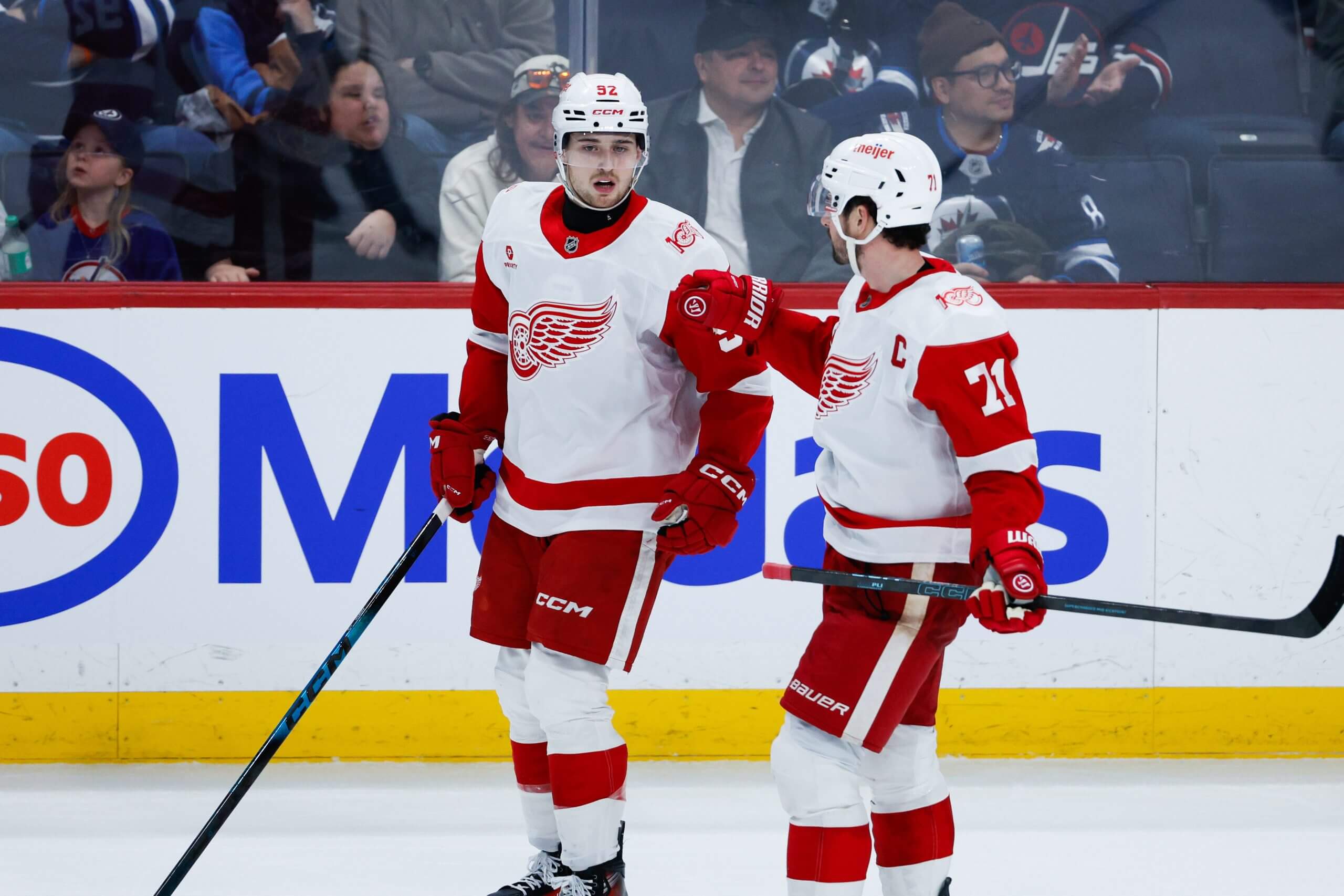 Dylan Larkin congratulates Marco Kasper on a goal.