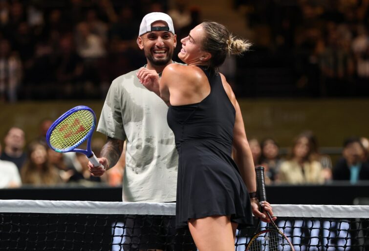 Nick Kyrgios, left, and Aryna Sabalenka interact at the net during their Battle of the Sexes match, in Dubai, United Arab Emirates, Sunday Dec. 28, 2025. (Christopher Pike/Pool Photo via AP)