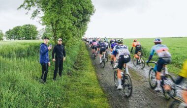 Riders pass by fans on a dirt 'ribin' sector at the 2025 Tro-Bro L&eacute;on