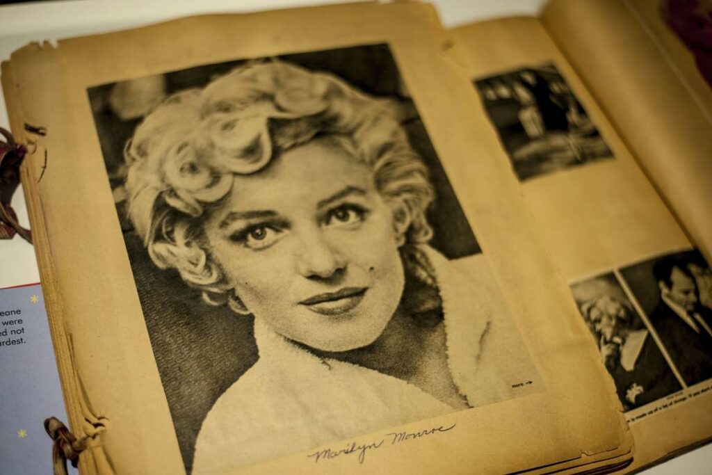 A book open to a page with an image of a young Marilyn Monroe in black and white.